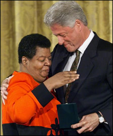 An emotional Elizabeth Eckford (left) embraces President Clinton as..