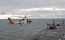 Coast Guard helicopter prepares to land on the flight deck of ...