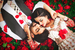 couple portrait surrounded by rose petals, wedding photo by Studio Uma ...