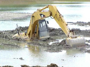 excavator sunk in mud