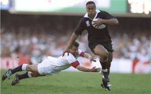 Catch me if you can: Jonah Lomu evades the diving tackle of Rob Andrew ...