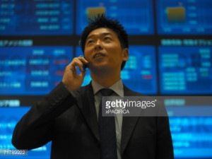 ... on a cell phone and screens with stock quotes. : Stock Photo