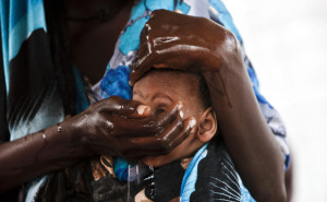newly arrived Somali refugee washes her child as they await medical ...