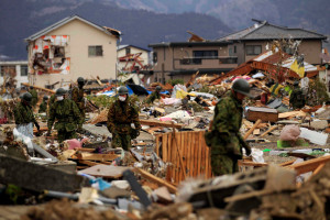 ... searched damaged areas of Ofunato for trapped survivors on Tuesday