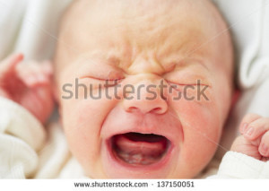 Newborn baby is crying - selective focus - stock photo
