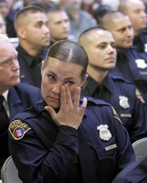 Image: Officer Choat wipes tears during her graduation in Cleveland