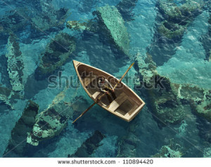 boat sails through the graveyard of sunken boats
