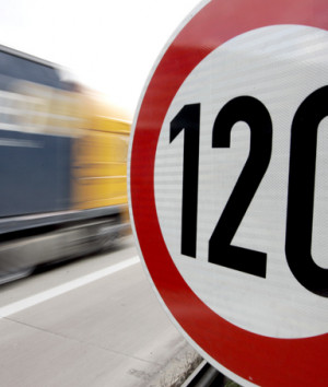 truck passes a 120 km/h (75 mph) speed limit sign on the A27 ...