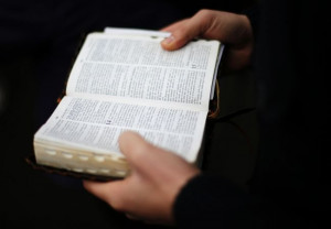 man holds a Bible, February 2, 2013. (REUTERS/Max Rossi)