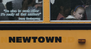 Students sit behind a quote by slain Sandy Hook Elementary School ...