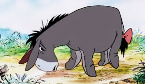 The old grey donkey, Eeyore stood by himself in a thistly corner of ...