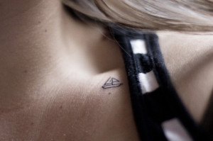 Tiny sailboat collarbone tattoo.