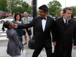 George Lopez clowns with a child as he arrives for the State dinner