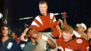 Husker players carry Coach Tom Osborne off the field after his first ...