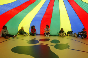 Physical education teacher Cindy Aillaud, center, sits with her third ...