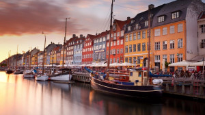 Colorful homes line Nyhavn Canal in Copenhagen, Denmark (© Benjeev ...