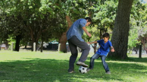 father and his sons are playing on the grass in the park | the baby ...