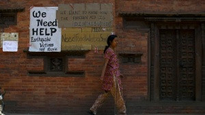 Earthquake victims put up a notice for help on the walls of a temple ...