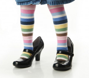 child's legs wearing horizontal striped, multi colored tights and ...