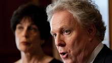 Quebec Premier Jean Charest speaks at a news conference as newly ...