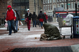 homeless person panhandles in the snow in Harvard Square, Cambridge ...