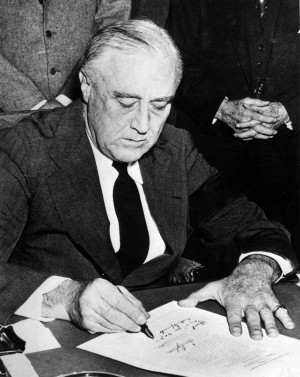 roosevelt signing the declaration of war after the infamy speech fdr ...