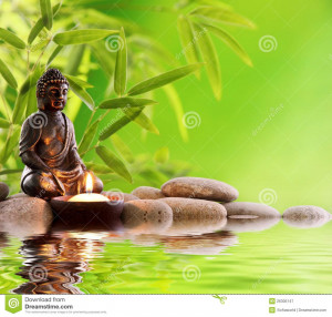 Buddha in meditation with burning candle,bamboo leaf and zen stones.