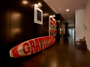 The condominium features a surfboard leaning against the wall with the ...