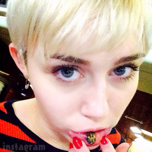 PHOTOS Miley Cyrus gets sad kitty lip tattoo