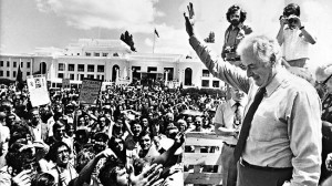 Gough Whitlam is surrounded by supporters the day after his government ...