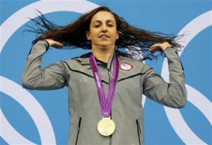 Rebecca Soni of the U.S. flips her hair as she poses with her gold ...