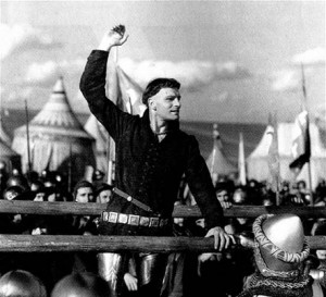 Laurence Olivier, playing Henry V, stirs his soldiers to heroism by ...