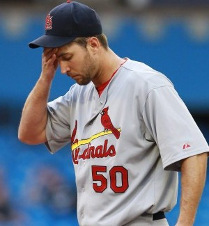 St. Louis Cardinals pitcher Adam Wainwright wipes his forehead during ...