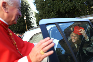 Vincent Nichols A religious sister plays with the biretta of new