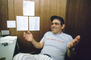 Yogi Berra, wearing one of his most famous sayings on his shirt, poses ...