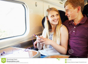 Royalty Free Stock Photo: Young Couple Listening To Music On Train