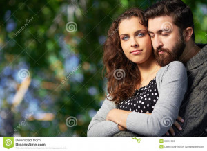 ... men embracing his girlfriend while she looking at camera outdoors