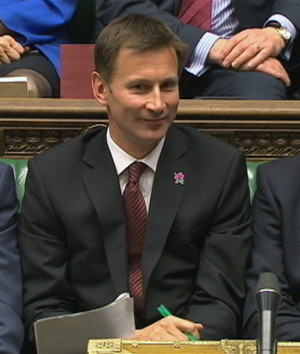 Britain's Culture Secretary Jeremy Hunt (C) sits flanked by Prime ...