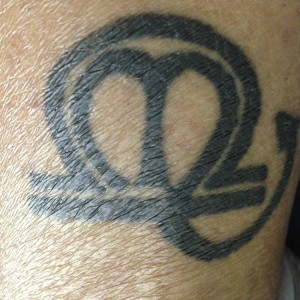 black-ink-libra-and-scorpio-zodiac-symbol-tattoo.jpg