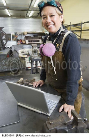 Female welder with laptop