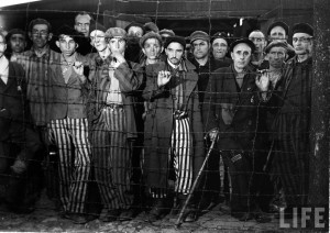 Margaret Bourke-White: Hollow-eyed male prisoners stare through barbed ...