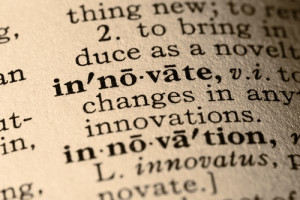 Close-up of the word innovate and innovation in a dictionary