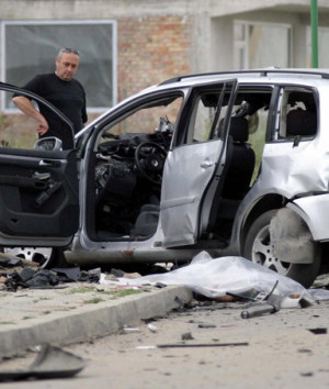 Bulgarian investigators search the scene of a car that was blown up in ...