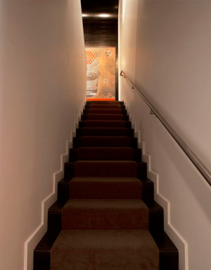 The staircase joins the upper floor living room from the lower hall