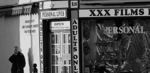 Bloke Having A Fag Outside A Sex Shop