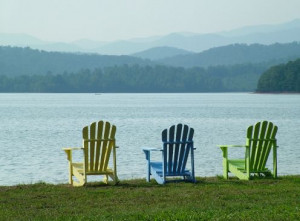 Adirondack chairs complete the relaxing feel of a lakeside retreat ...