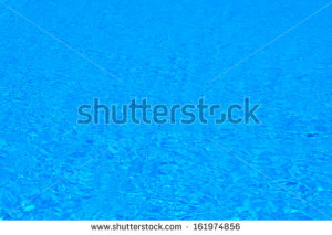 ... of blue water in the pool with the reflection of the sun