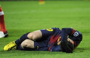 Barcelona's Lionel Messi reacts after picking up an injury while ...