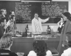 Stock Photo : Female science teacher pointing to blackboard with quote ...