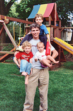 Holding Logan and Chloe, with Dylan on his shoulders, 2007